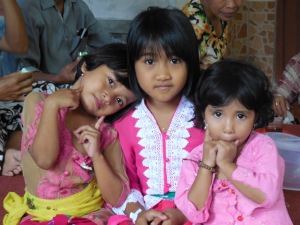 Putu's 7-year old sister flanked by her friends
